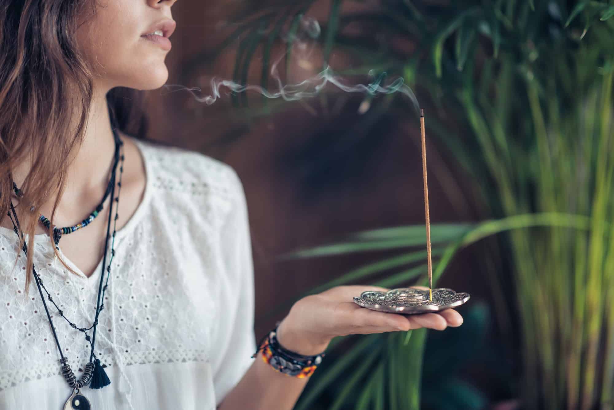 Incense Stick. Caucasian Woman Enjoying Aroma Stick